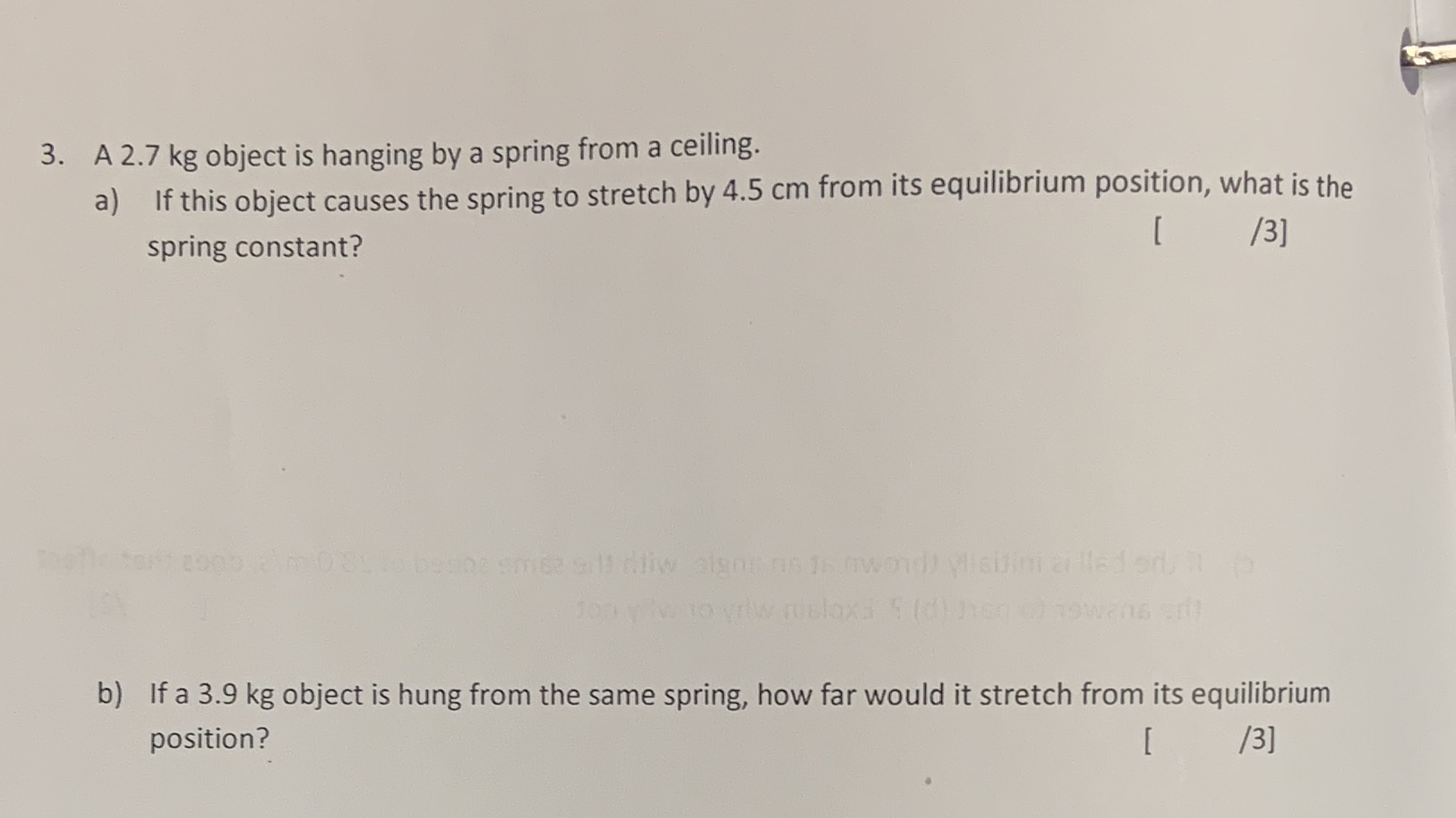 3. A 2.7 kg object is hanging by a spring from