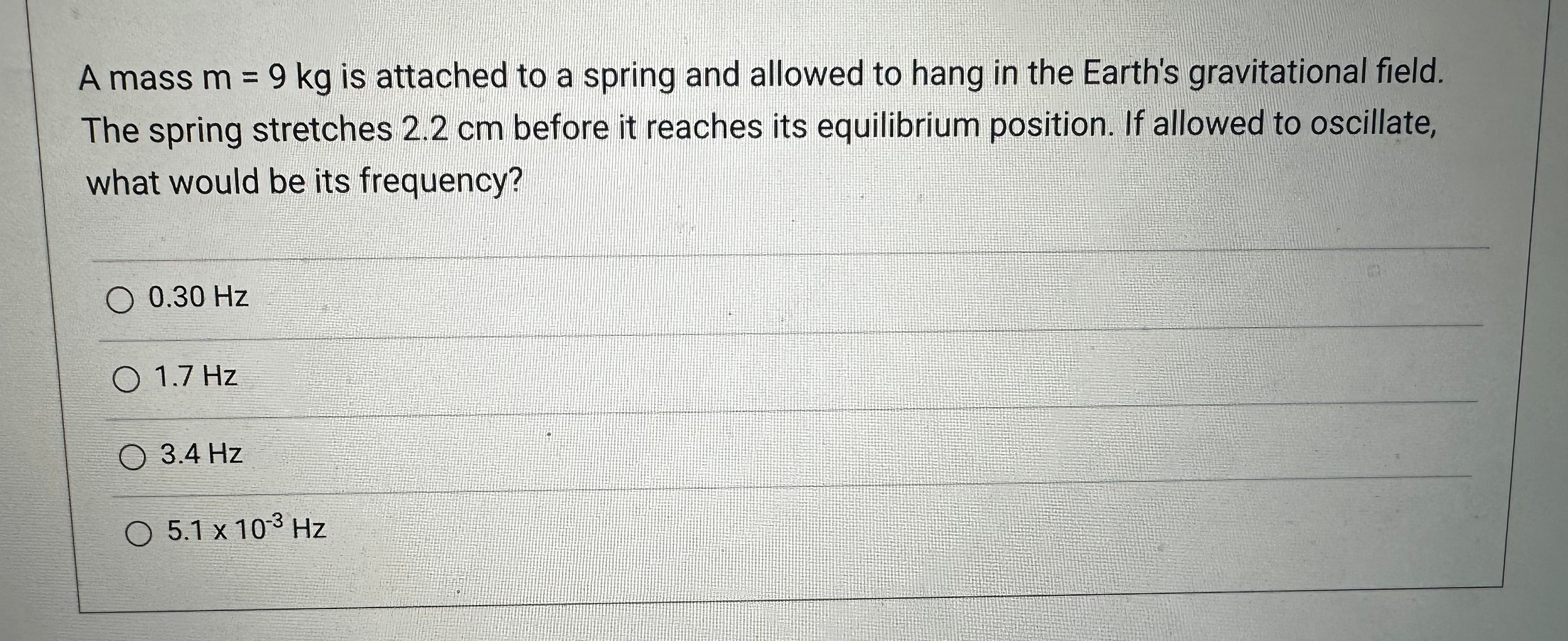 and allowed to hang in the Earth's gravitational field. The spring stretches