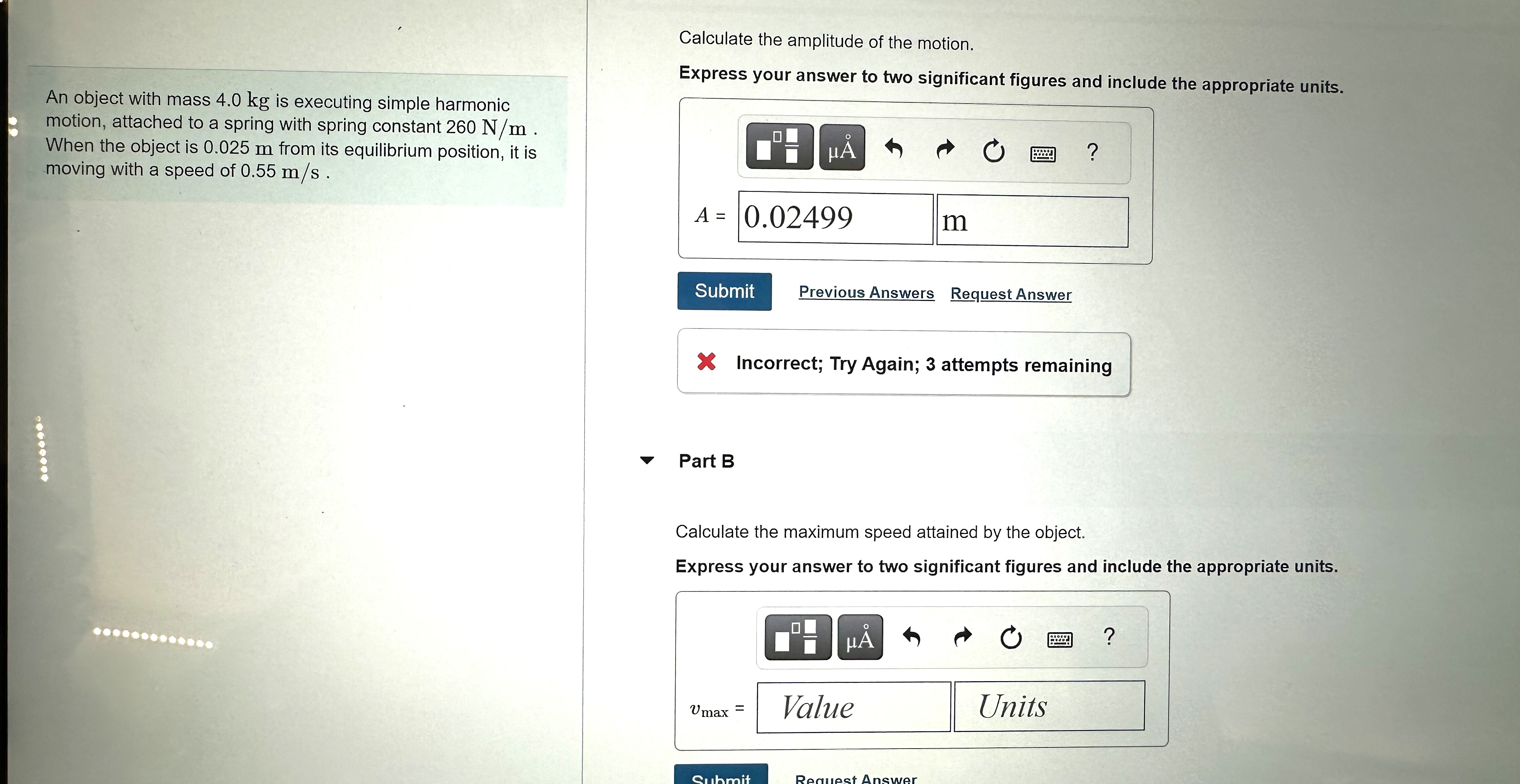 The mass passes through the equilibrium point (y = 0) with positive
