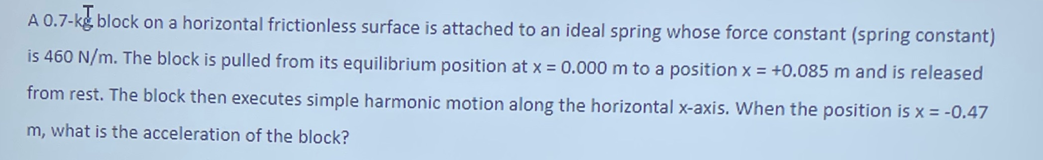 A 0.7-kg block on a horizontal frictionless surface is attached to