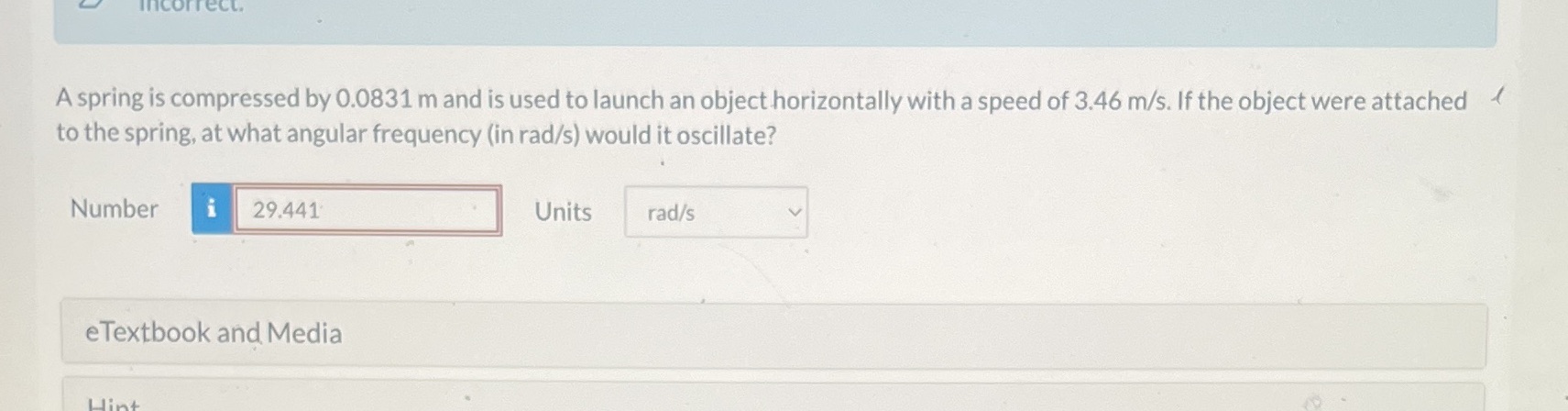  A spring is compressed by 0.0831 m and is used to