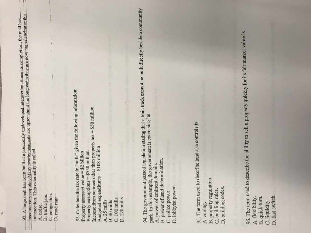 A large mall has been built at a previously undeveloped intersection.