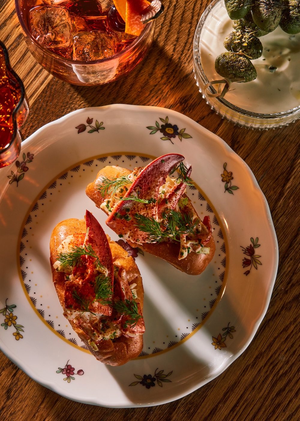 a plate of lobster rolls on a wooden table