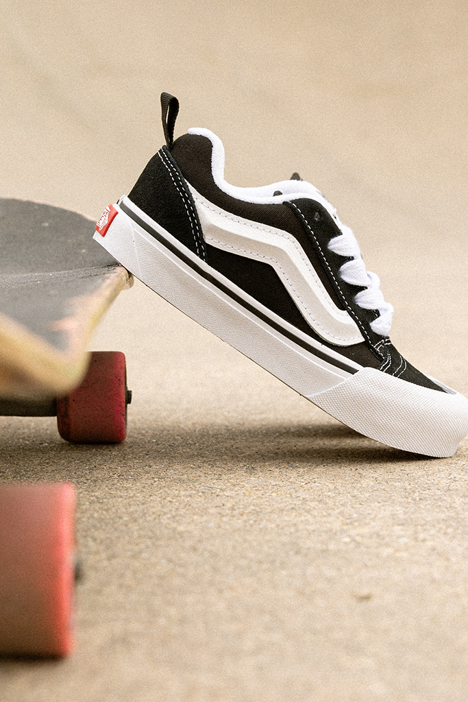 Knu Skool Vans next to a Skateboard