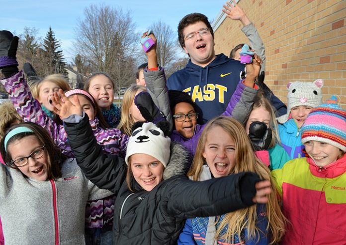 EGRHS_cadets_1 Teacher cadet Tomer Adnegeko at recess at Breton Downs Elementary with a group of enthusiastic admirers