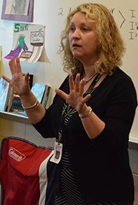 Cedar Springs seventh-grade teacher Amy Blauw tells her students what to listen for as they read along to “The Gardener”