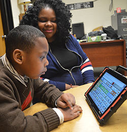 Daniel Donaldson uses his reader with his mom, Christina Donaldson