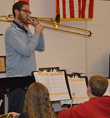Kent City band director Jonathan Schnicke demonstrates articulation on his trombone