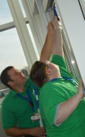 Nathaniel Plude of Comstock Park High gets help with hard-to-reach spots from CORE Director Michael Spagnuolo