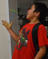 Student David Garcis-Alonzo make a toy fly