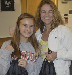 Seventh-grader Lauren Massa and her mother, Kelly, help out with other volunteers from Rockford United Methodist Church