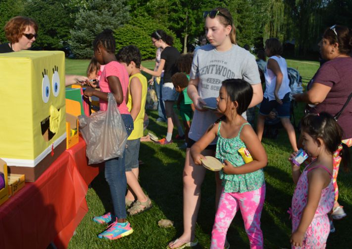 Students play carnival games for school supplies
