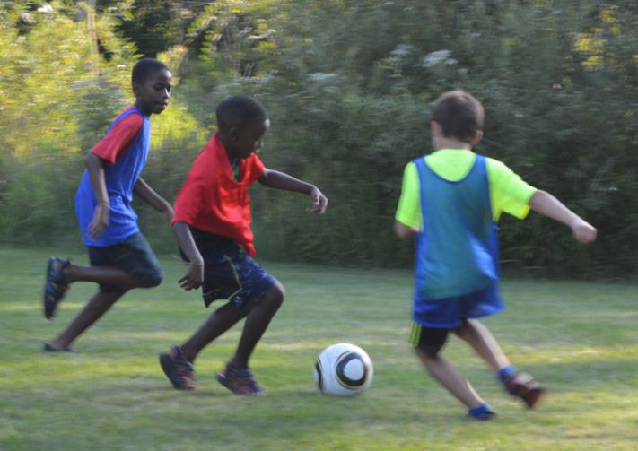 Students have plenty of room for soccer, bouncing on an inflatable and getting wet in the sprinklers at the Kentwood community party