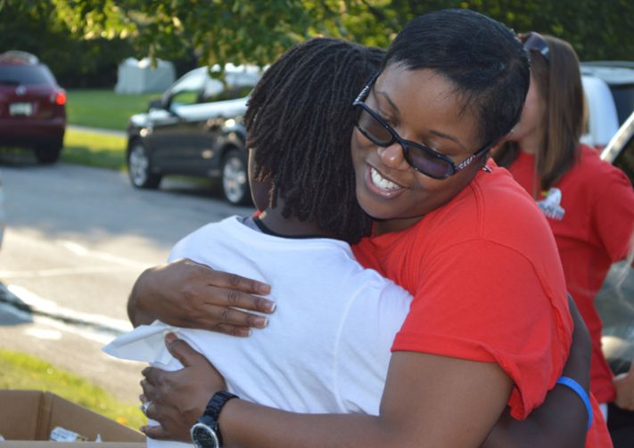 Endeavor Elementary School fourth-grade teacher Sheree Bos hugs Pinewood Middle School seventh-grader Sonia Franks