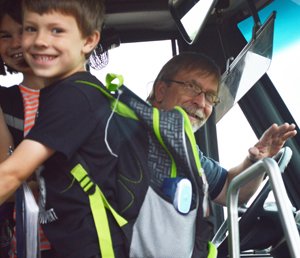Students boards the bus with driver Dave Smith at the wheel