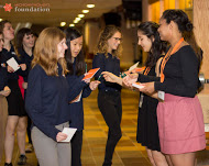 Young Women for Change members Ana Lopez and Morgan Locke (far right) pass out journals to GRPS students