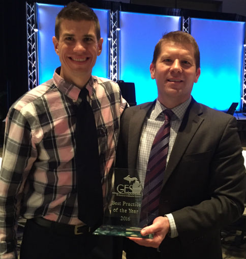 Design Lab instructor Joe Phillips, left, receiving the award with Tech Center Principal John Kraus