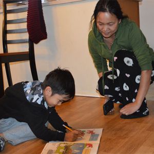 Mother Nzun Chin watches John, 4, trace
