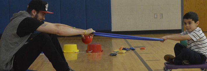 River Valley senior Jacob Murray, here swinging Parkside kindergartner Jacob Rosario-Barrios around the gym, says he loves helping kids