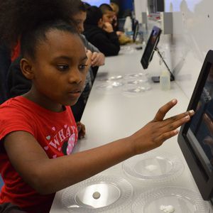 Ayzjah Jackson enters information at an iPad station