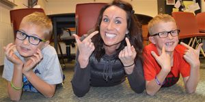 School social worker Ginny Grit, center, clowns around with fifth-graders Zachary Ueland, left, and Aiden Sullivan