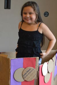 Second-grader Irais Gonzalez-Ibarra greeted people from her cardboard house
