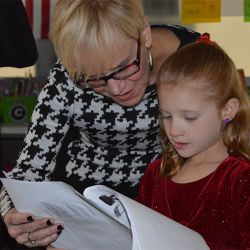 Principal Barb Johnson looks at a Brown Elementary School students story