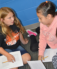Kendall DuBuis and Sabrina discuss text introduced in a mini-lesson