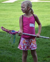 A Grandville elementary student tries lacrosse during the 2014 Girls Sports Day event