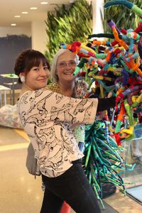 Pam Jasperse, art teacher at Forest Hills MeadowBrook Elementary and her student teacher, Naomi Poel from Kendall College of Art and Design, pose near “Connectivities”