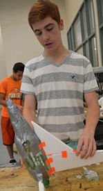 Eighth-grader Preston Mullins works on his design