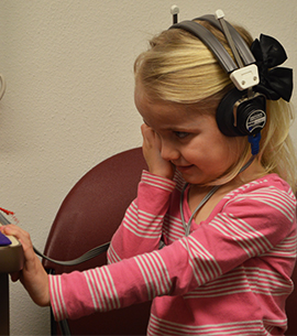Alexis Ehling, 4, receiving a follow-up hearing screening at the Kent County Health Department