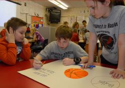Working together on an anti-bullying poster are (from left) A.J. Gates Joshua Vick and Emma Cassiday