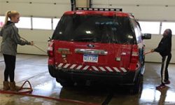 Students wash the Kentwood Fire Station's emergency vehicles
