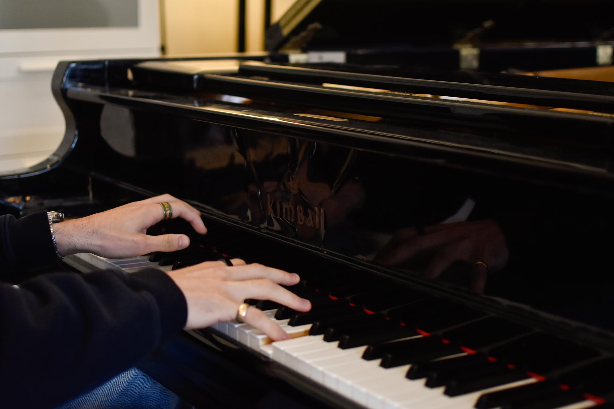 Fingers playing a piano