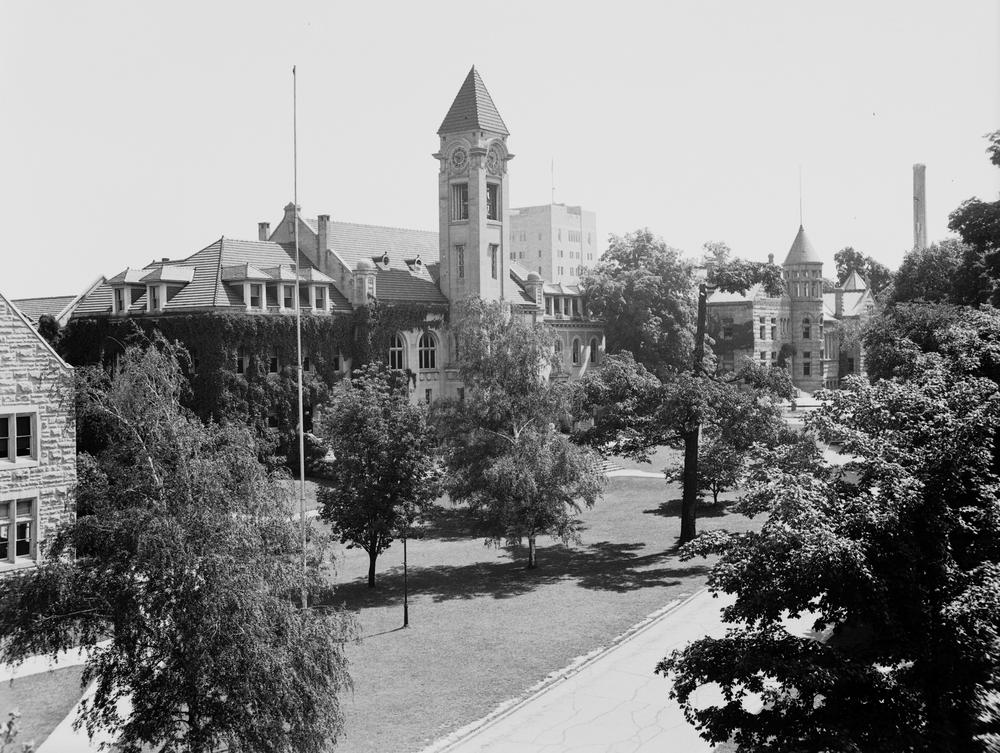 a black and white photo of a limestone building with a tall turret