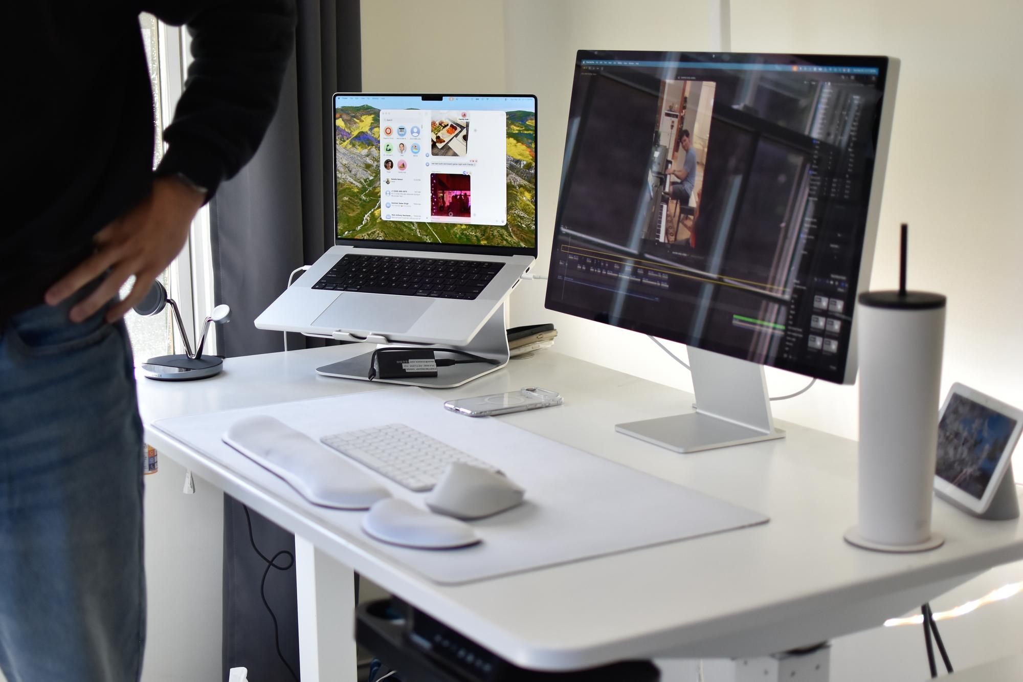 A white desk with a computer and laptop.