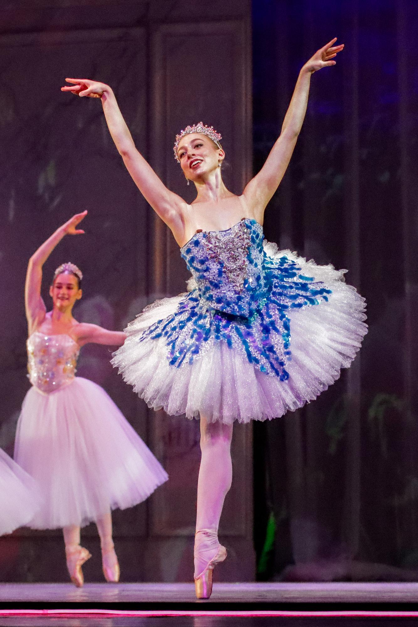 A dancer in a blue leotard
