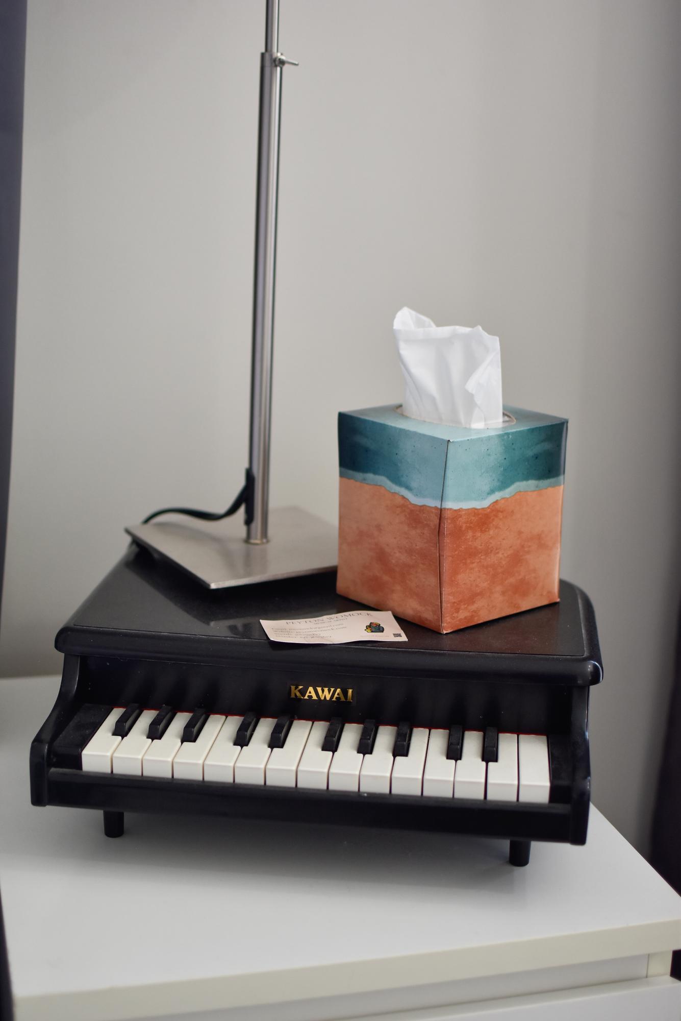 A lamp on a small piano.