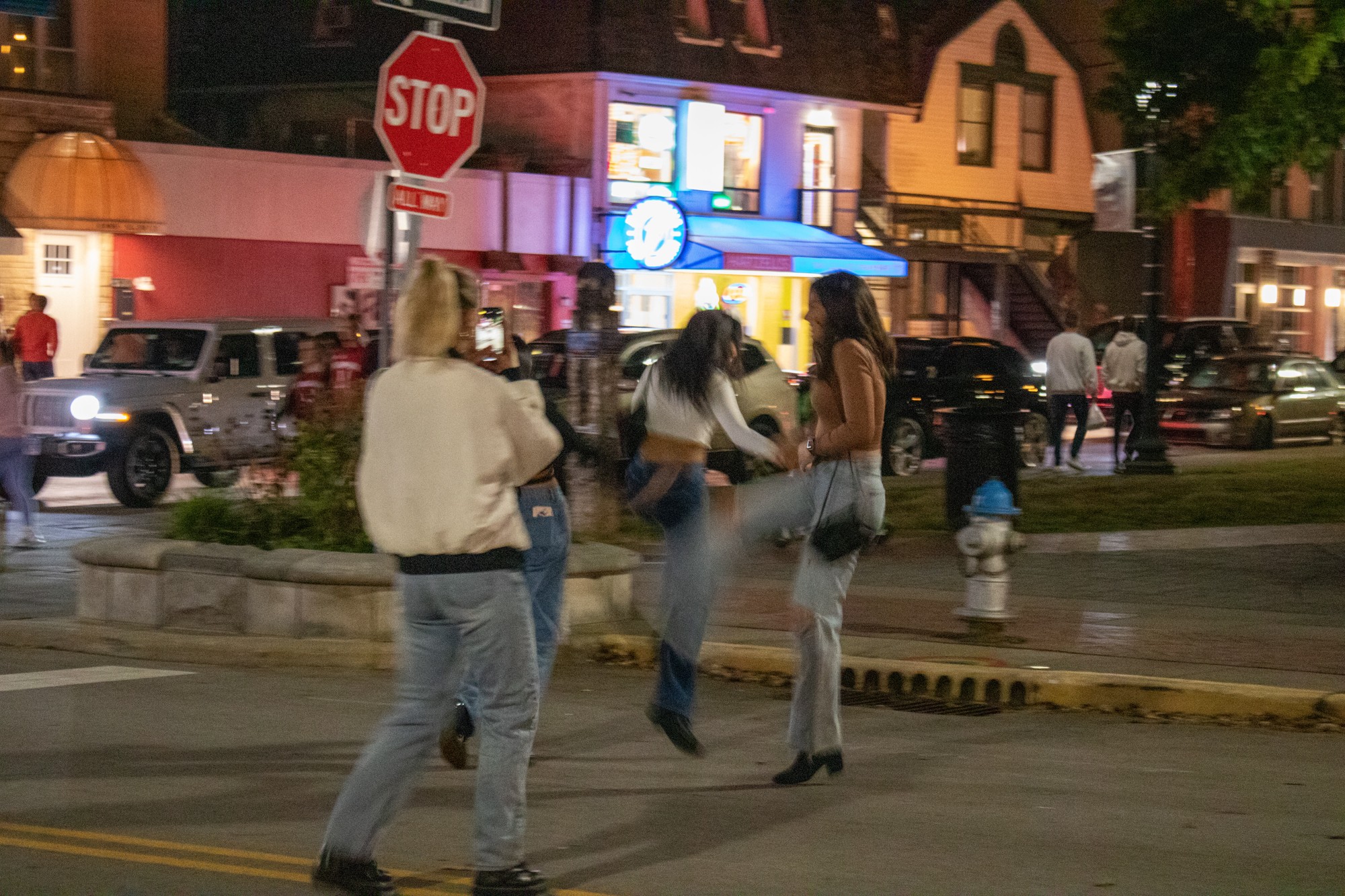 A group of people out on Kirkwood Avenue dancing.