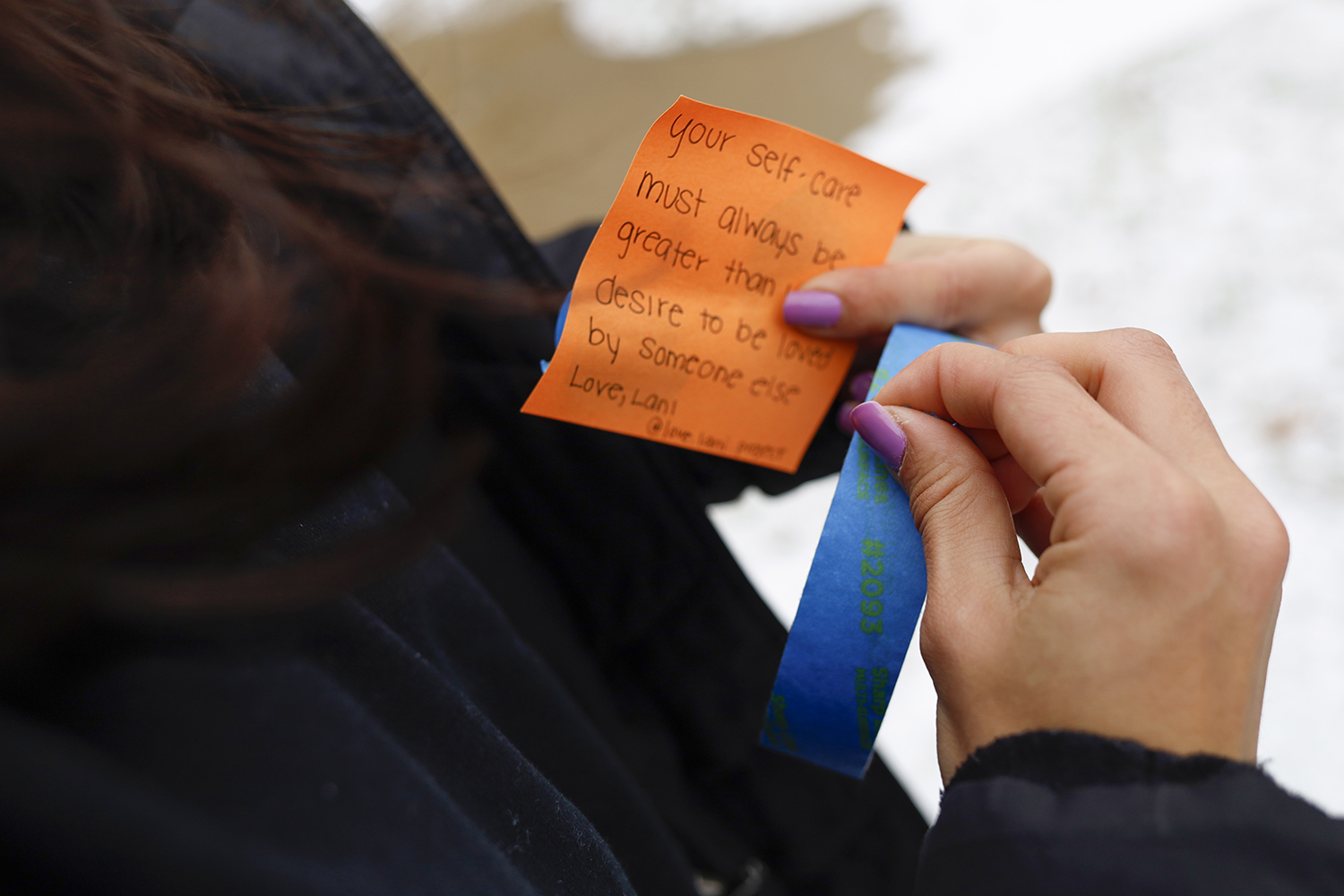 woman holds inspirational note