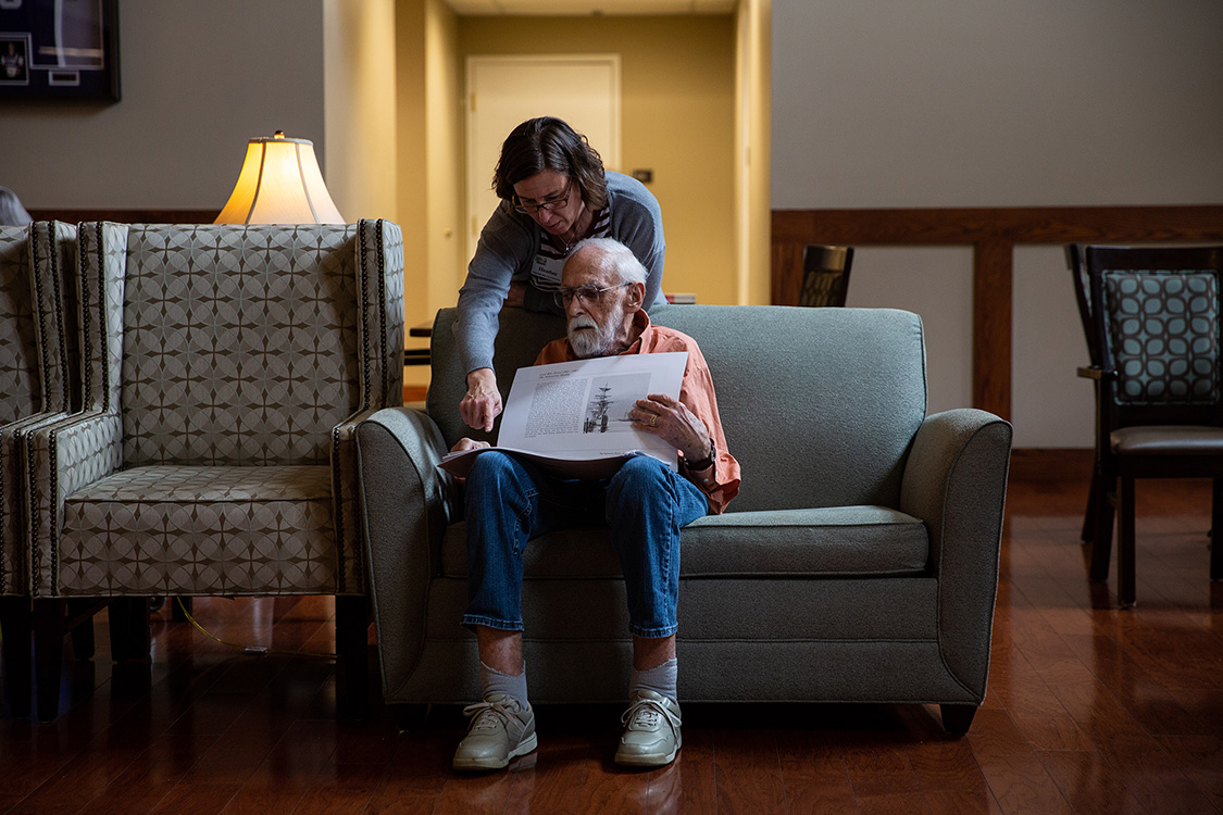 Jim looks through old paintings.