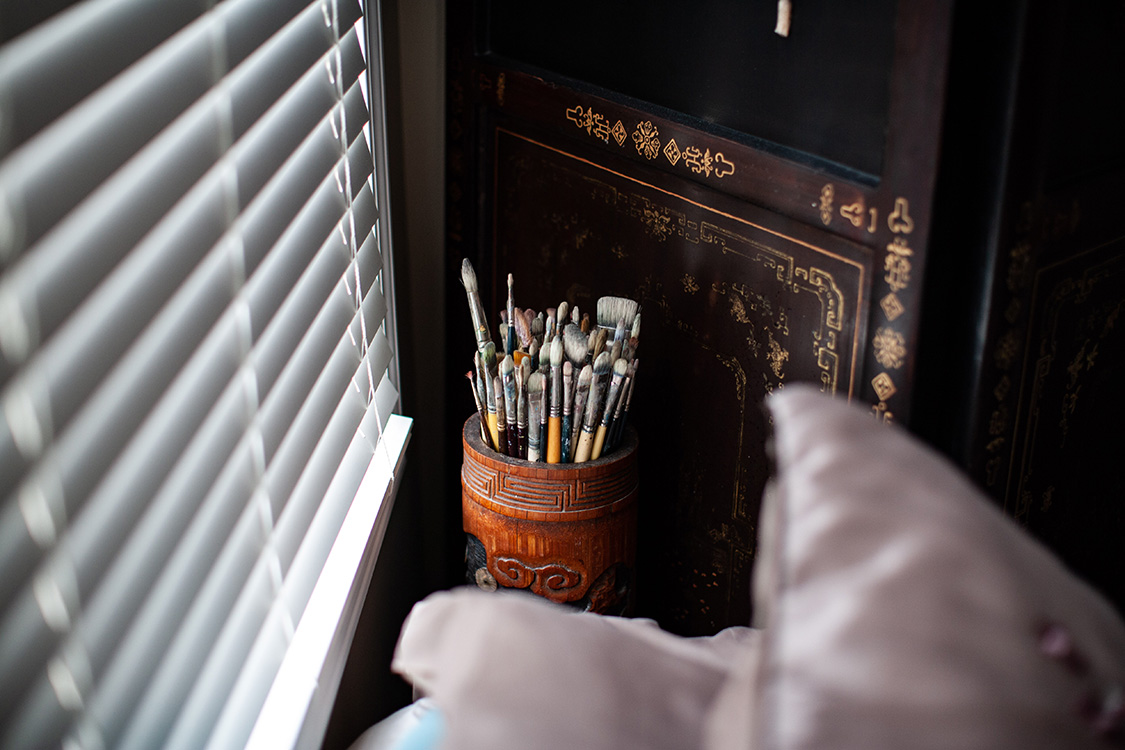 Jim's paintbrushes next to Fran's bed