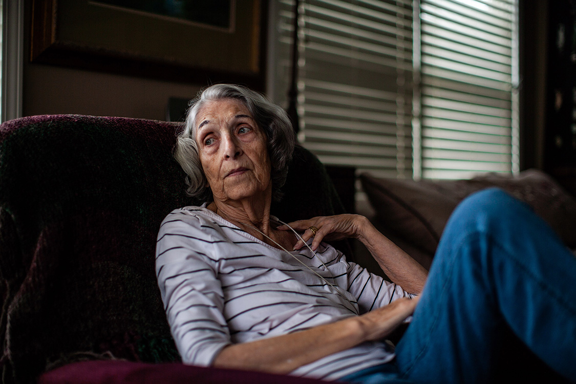 Fran sits in her room.