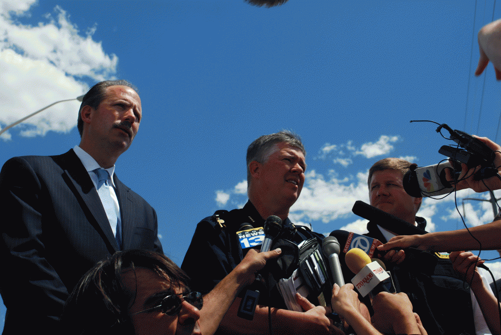APD Police Chief Ray Schultz answers questions from reporters as Mayor Richard Berry, left, and Public Safety Director Darren White look on. Berry commended APD officers for their quick response and heroism.