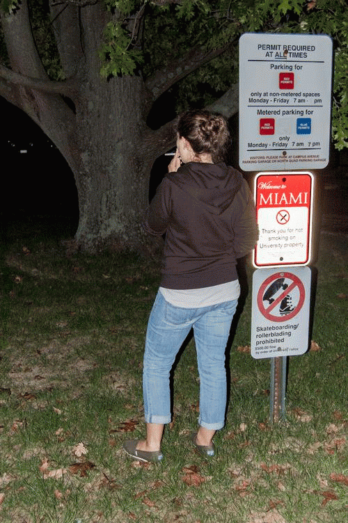 A student smokes outside the Shriver Center, despite Miami University’s smoke-free campus policy.