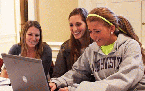 Senior Katie Knable and sophomore Colleen Ryan help first-year Isabelle Bromberg print a proof of address letter.