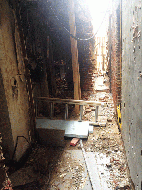 What remains of the fraternity brothers’ burnt belongings lay scattered on the floor of the Phi Gamma Delta (FIJI) fraternity house after the fire May 25, 2013.  The Bureau of Alcohol, Tobacco, Firearms and Explosives recently visited the house to continue investigating what they believe to be a case of arson.