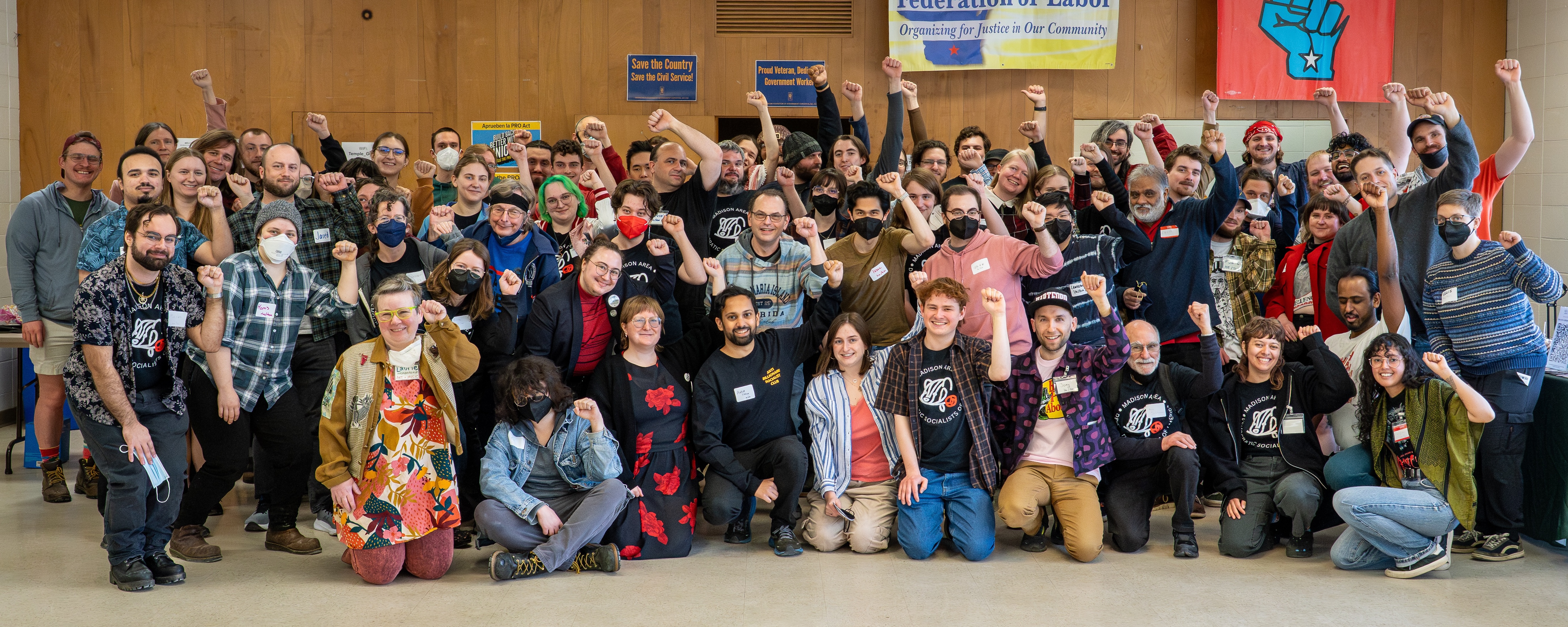 Madison Area DSA members raising their fists for a group photo