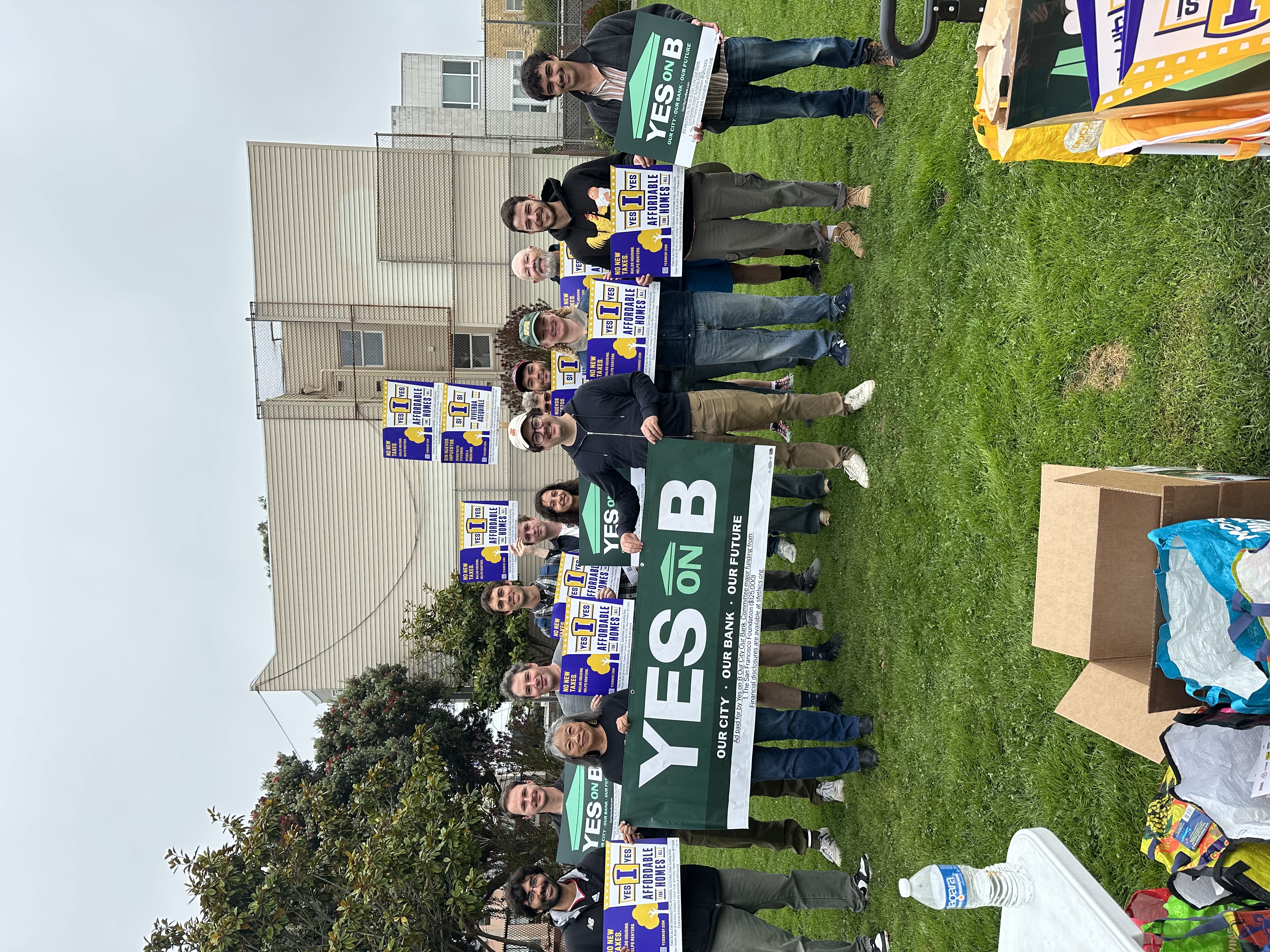 Group of comrades holding both Yes on B and Yes on I posters